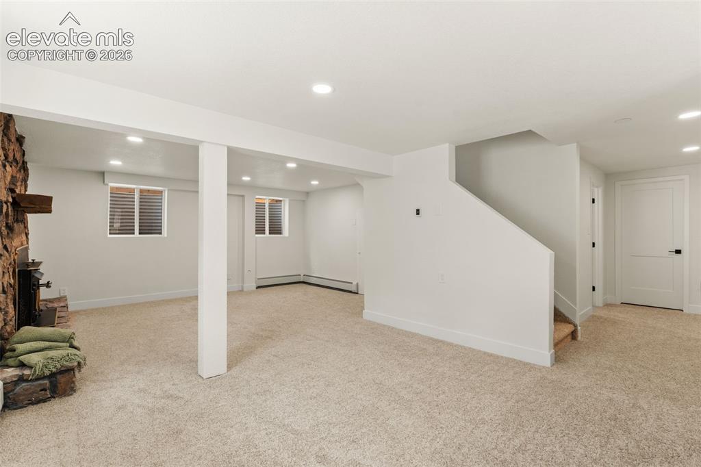 Image 30 of 43: Finished below grade area with recessed lighting, light colored carpet, sta