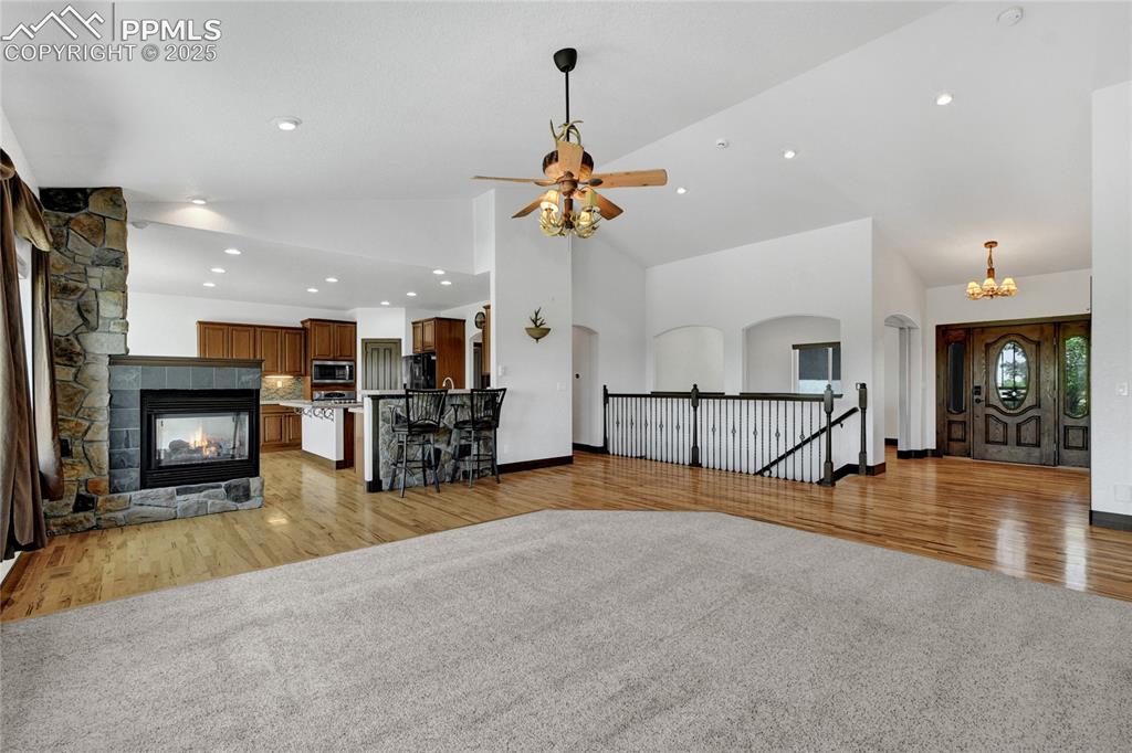 Image 12 of 40: There is a dual sided fireplace to the kitchen.