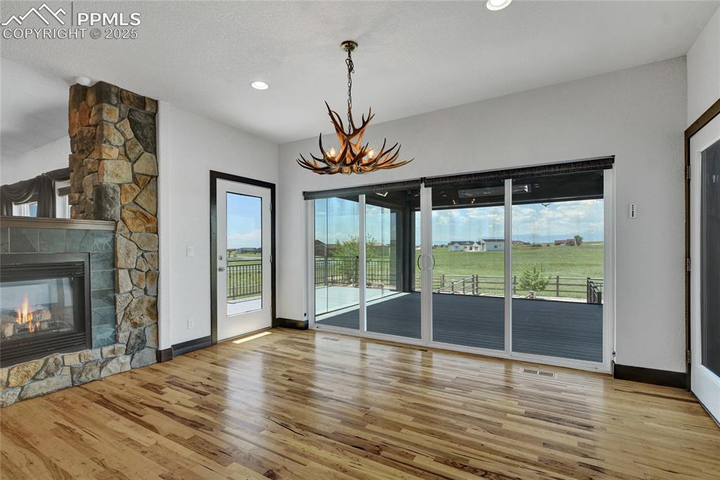 Image 15 of 40: This dining space opens up to the 4 seasons sunroom which has heaters for y