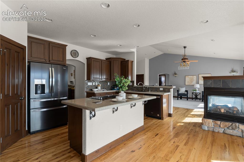 Image 17 of 40: Chef’s kitchen with stainless steel appliances, solid surface countertops,