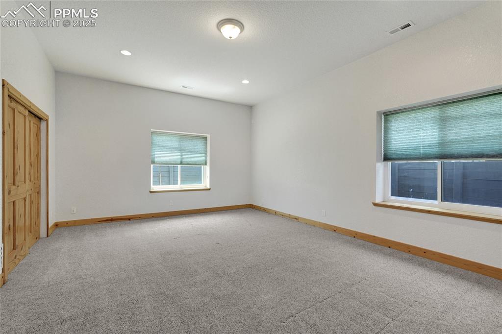 Image 34 of 40: The basement bedrooms are bright and spacious with dual closets.