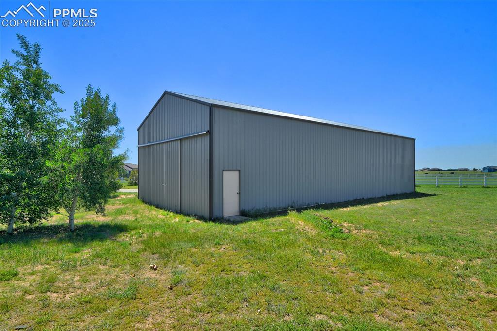 Image 5 of 40: 50x60 storage building with 3 12x14 overhead doors, one with an opener. Th