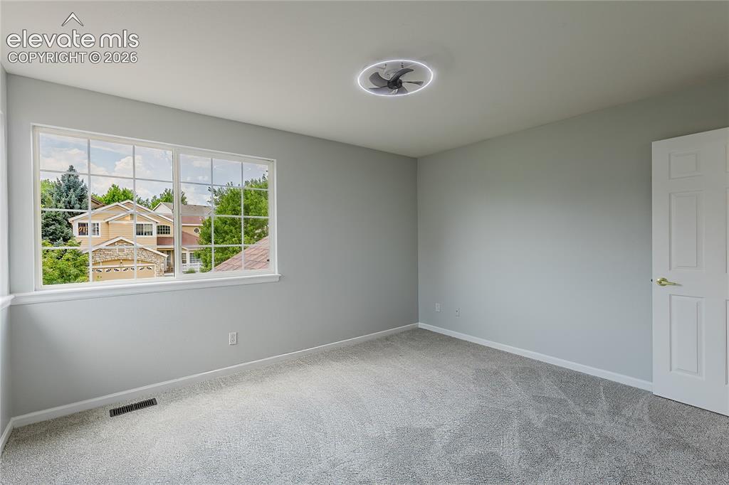 Image 31 of 46: Light gray walls, light gray carpet flooring, ceiling-mounted light fixture