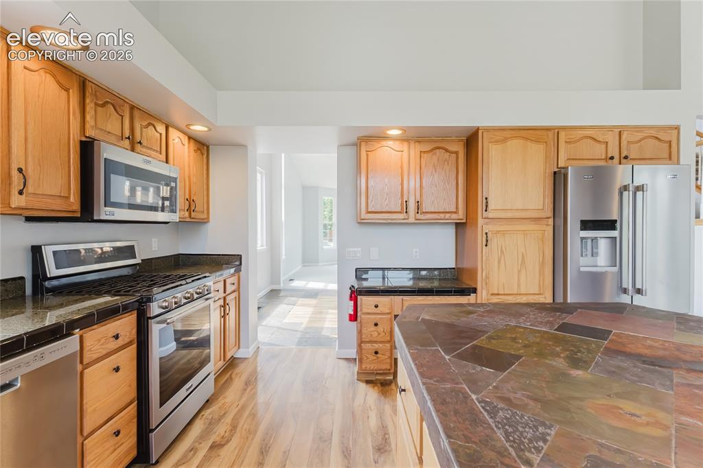 Image 32 of 46: Kitchen featuring wood cabinetry, stainless steel appliances, recessed ligh