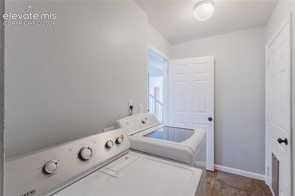 Image 37 of 46: Utility area with tile flooring and a flush-mount ceiling light