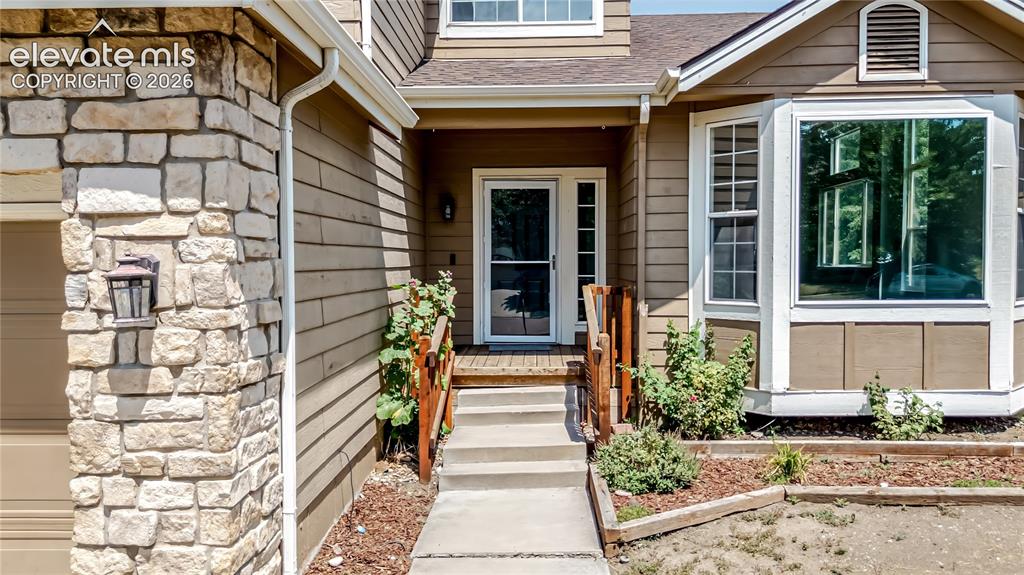 Image 44 of 46: Stone veneer accents a siding exterior