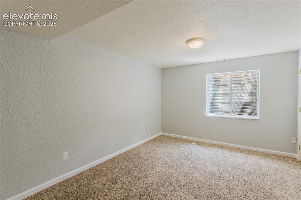 Image 5 of 46: Carpeted flooring, light-toned walls, and a flush mount ceiling light