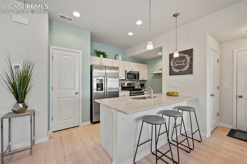 Image 9 of 22: OPEN KITCHEN WITH LARGE ISLAND, STAINLESS STEEL APPLIANCES, QUARTZ COUNTER