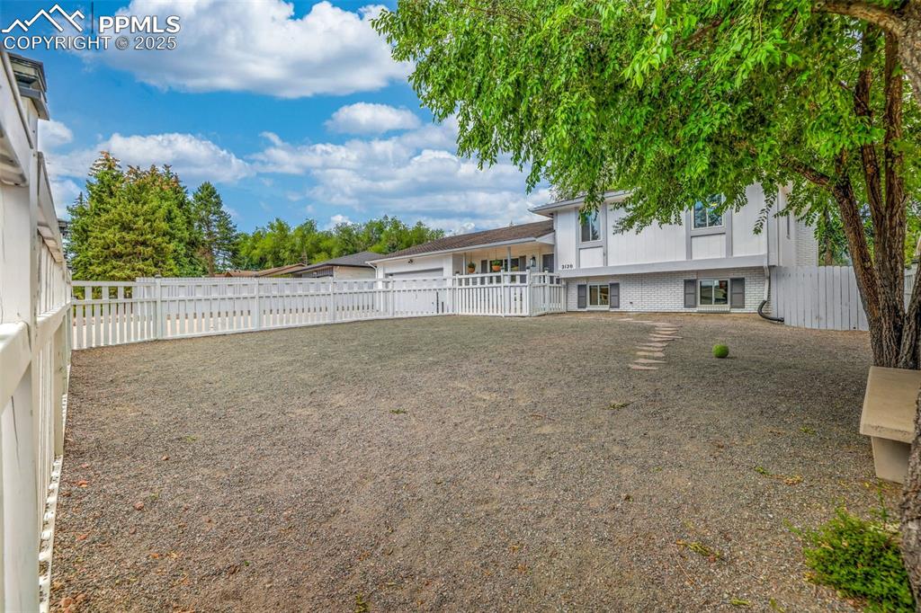 Image 12 of 50: View of fenced backyard