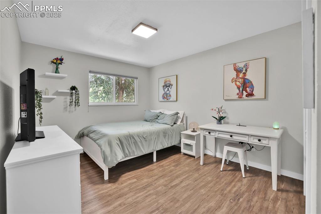 Image 29 of 50: Bedroom with light wood finished floors and baseboards