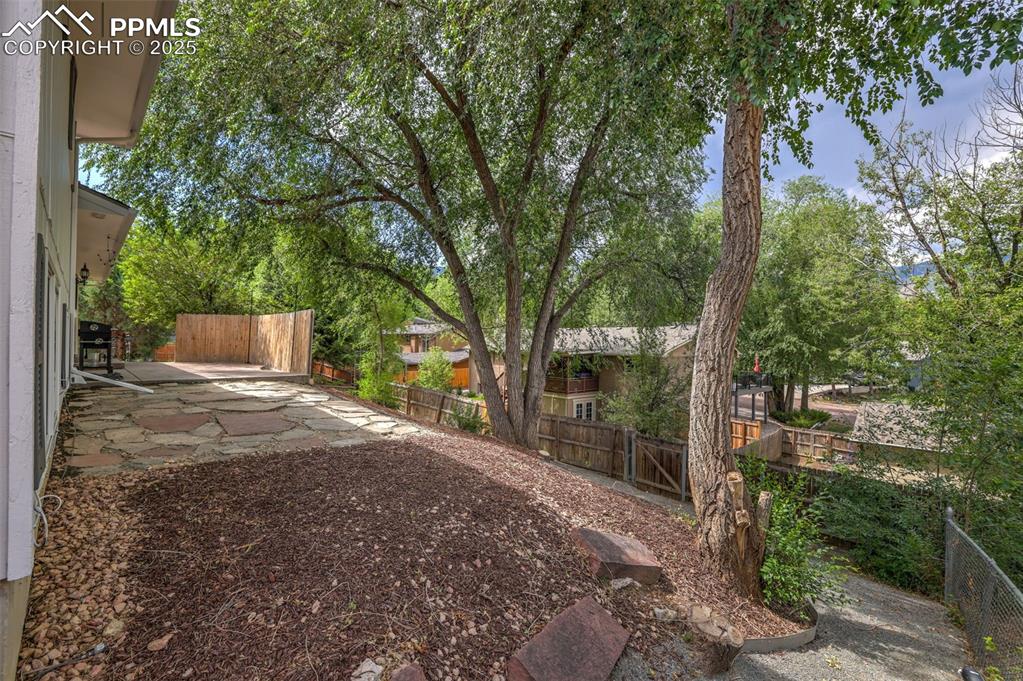 Image 48 of 50: Fenced backyard featuring a patio area