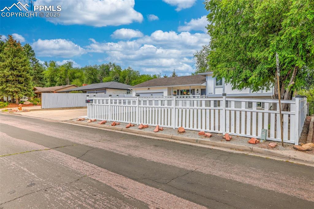 Image 9 of 50: View of front of home featuring a fenced front yard and concrete driveway