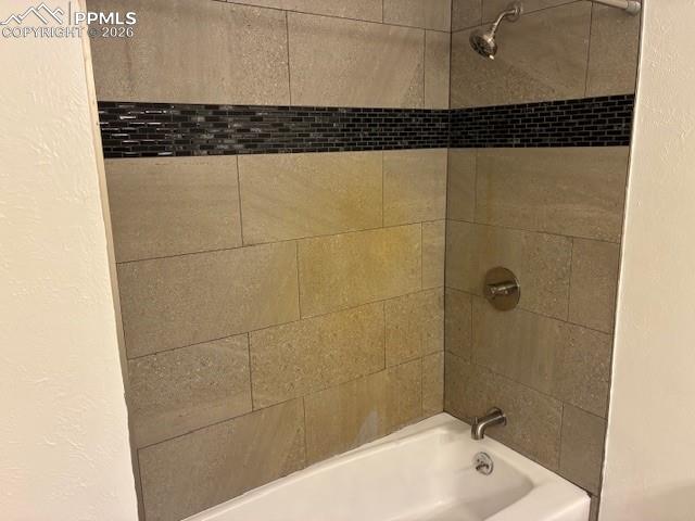 Image 14 of 36: Full bath featuring shower / washtub combination and a textured wall