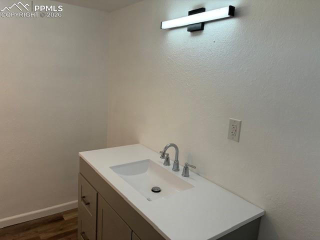 Image 23 of 36: Bathroom with vanity and dark wood-type flooring