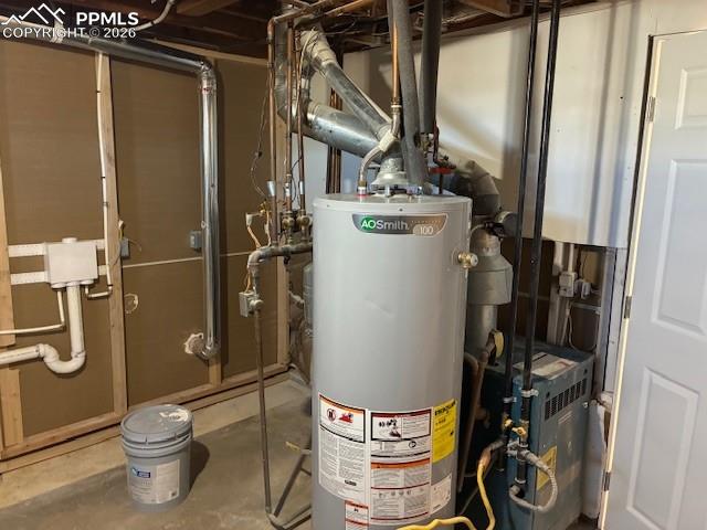 Image 28 of 36: Utility room featuring gas water heater and a heating unit