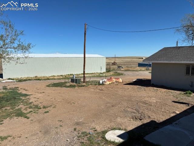 Image 31 of 36: View of yard with an outdoor structure and an outbuilding