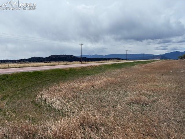 Image 32 of 36: View of mountain backdrop with rural landscape