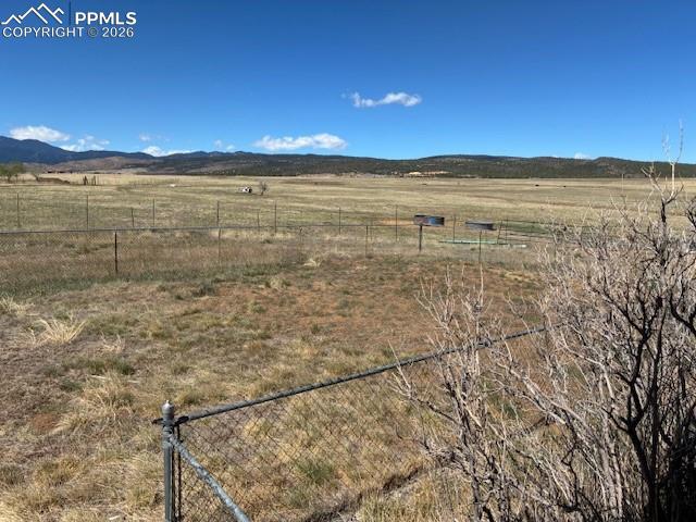 Image 34 of 36: View of mountain backdrop with rural landscape