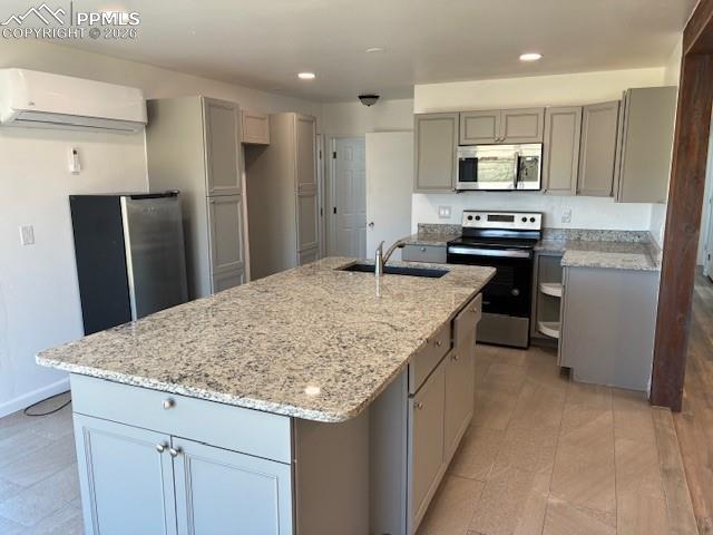 Image 5 of 36: Kitchen with gray cabinetry, stainless steel appliances, recessed lighting,
