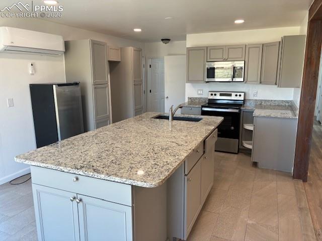 Image 7 of 36: Kitchen with gray cabinets, stainless steel appliances, recessed lighting,