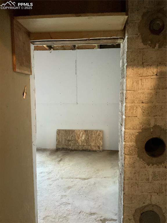 Image 32 of 39: Garage with entry to Mechanical room or else.