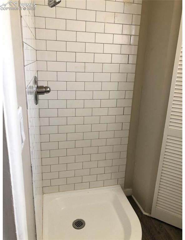 Image 37 of 39: Shower stall of apartment in back