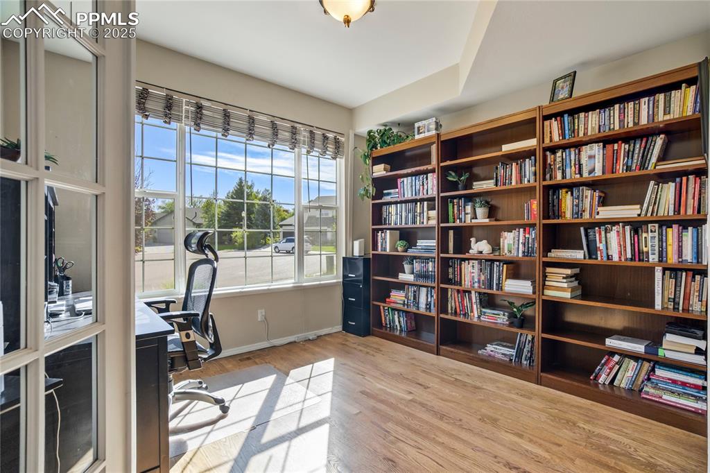 Image 14 of 43: Office space with light wood-type flooring and baseboards