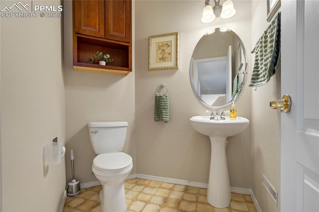 Image 16 of 43: Bathroom featuring toilet and baseboards