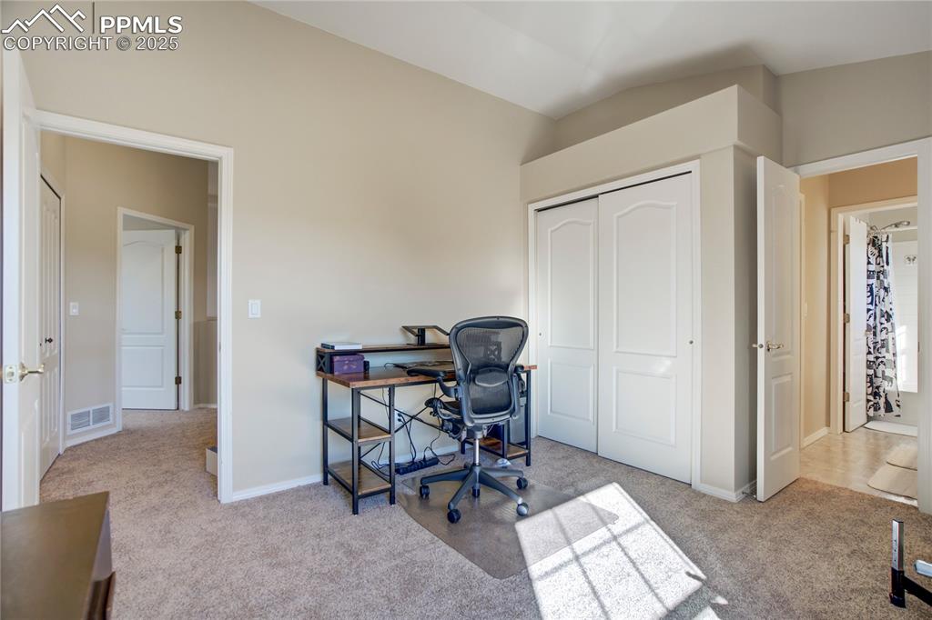Image 24 of 43: Home office featuring light carpet and vaulted ceiling