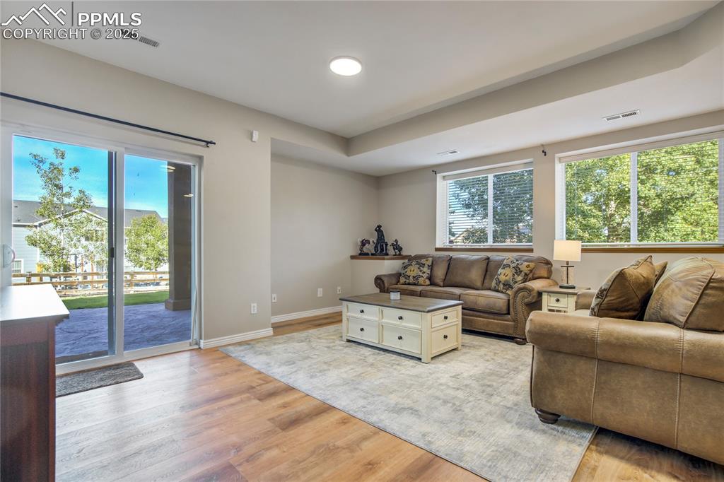 Image 28 of 43: Living area with light wood-type flooring and baseboards