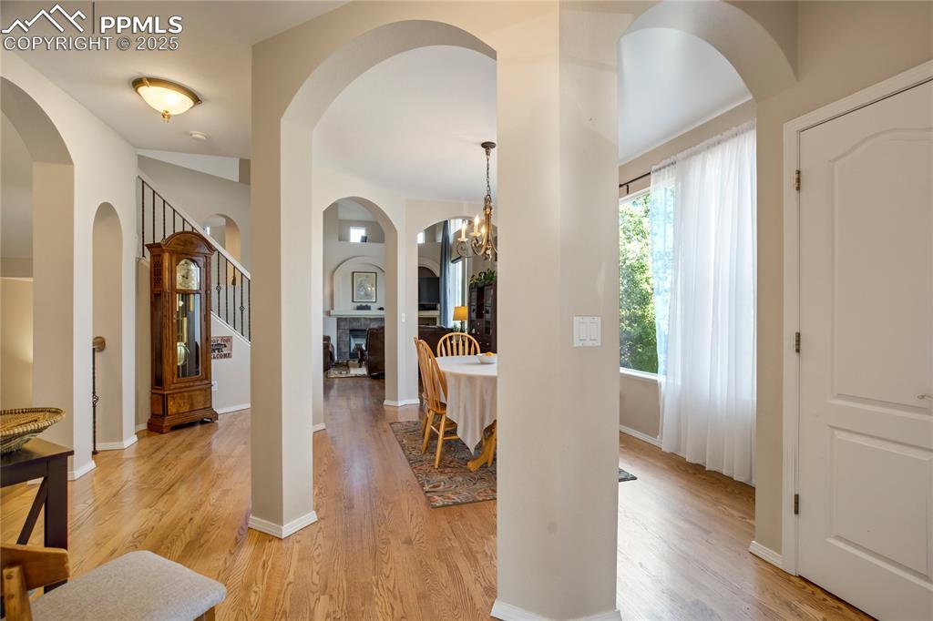 Image 3 of 43: Foyer entrance featuring arched walkways, light wood-style floors, stairs,