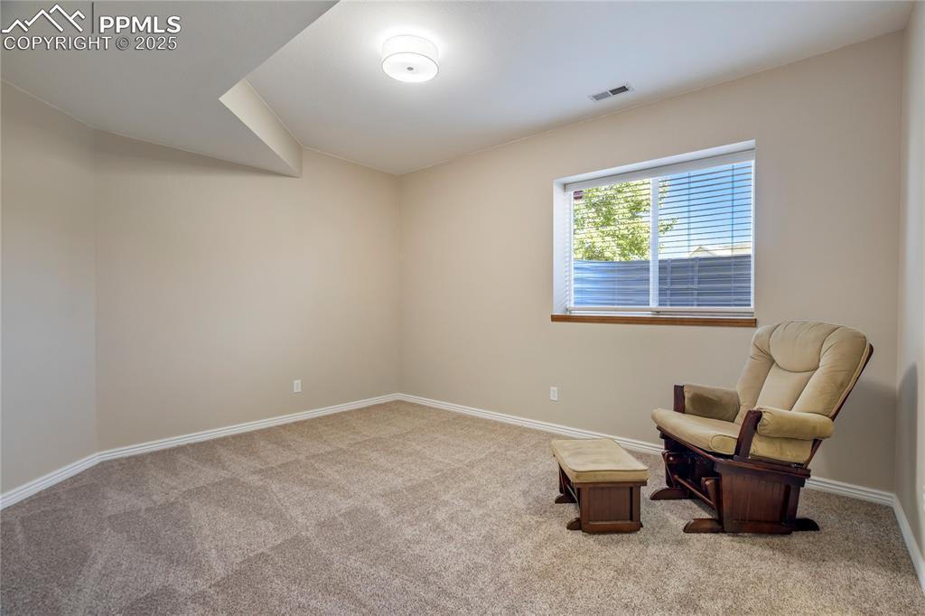 Image 32 of 43: Sitting room featuring light colored carpet and baseboards