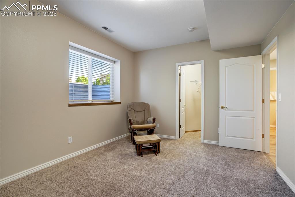 Image 33 of 43: Living area with carpet flooring and baseboards