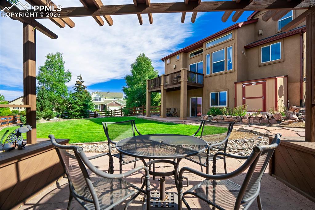Image 35 of 43: View of patio with outdoor dining space and a deck