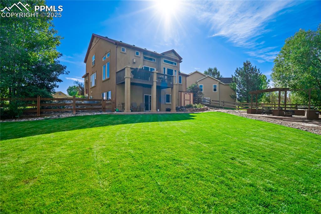 Image 38 of 43: Rear view of house featuring a patio area and stucco siding