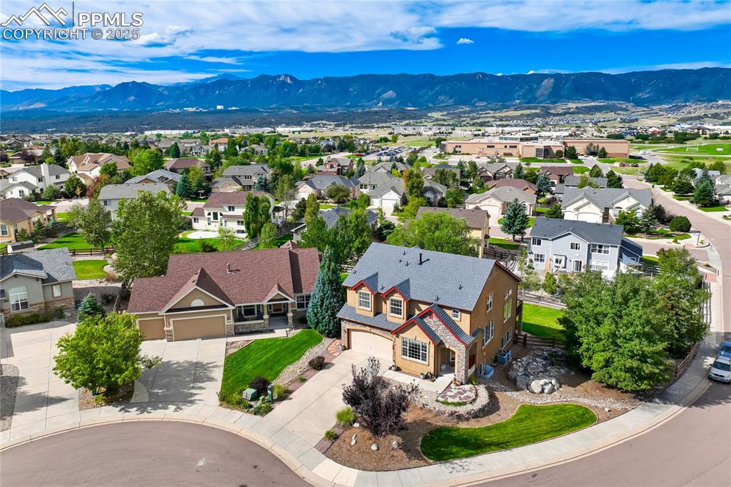 Image 43 of 43: Aerial perspective of suburban area with a mountainous background