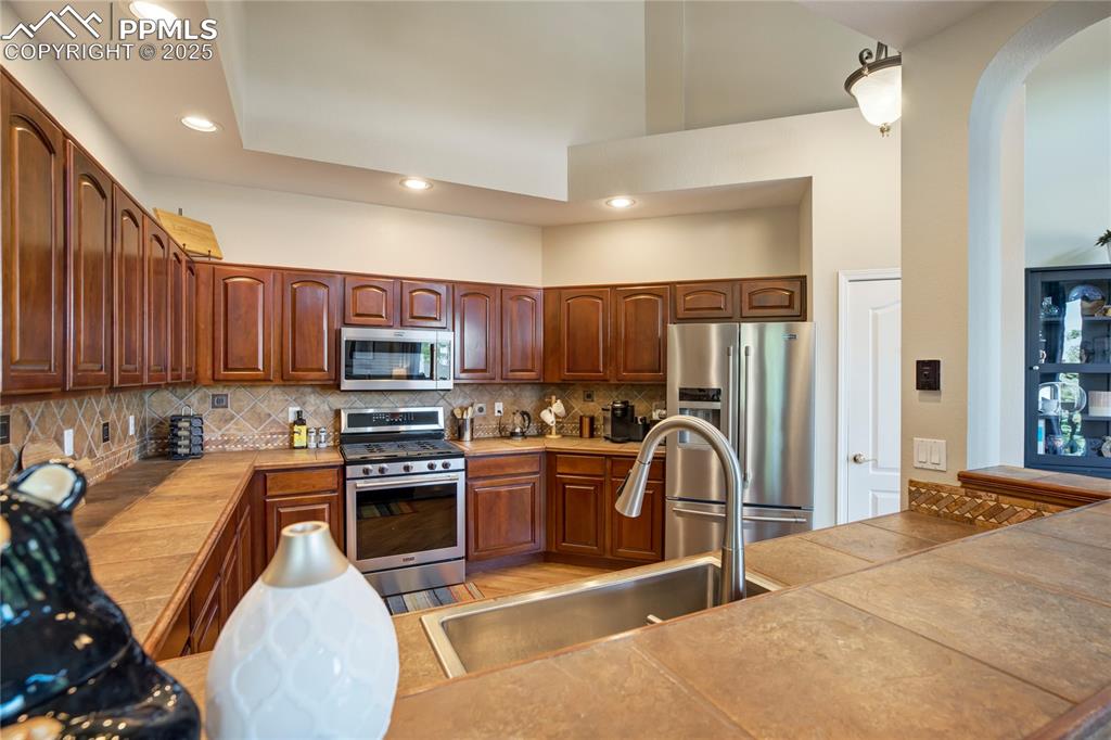 Image 9 of 43: Kitchen featuring appliances with stainless steel finishes, recessed lighti