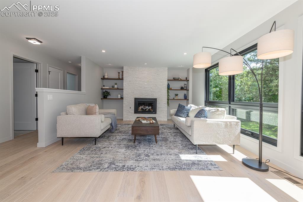 Image 11 of 50: Formal living with fireplace and built ins