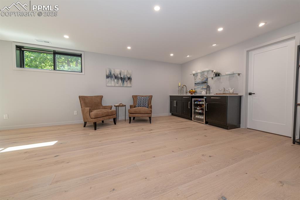 Image 30 of 50: Basement Rec Room wet bar and game table area