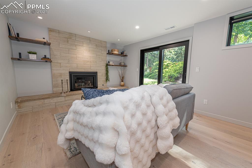Image 33 of 50: Basement family room with walk out and fireplace