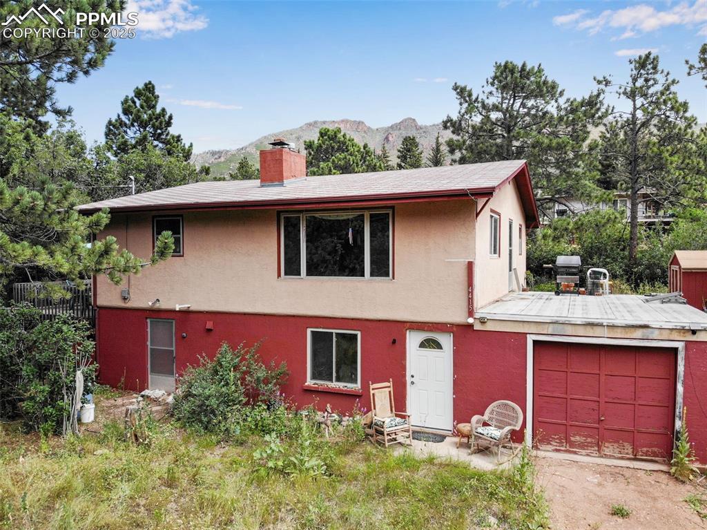 Caption: View of front featuring stucco siding and large open windows