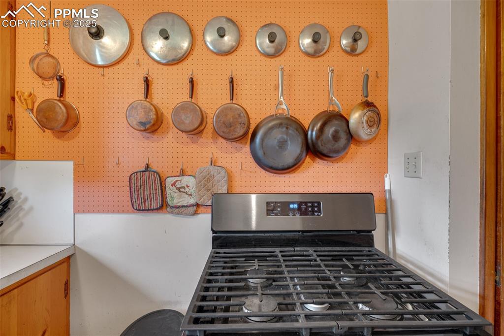 Image 14 of 50: Kitchen view of stainless steel gas stove