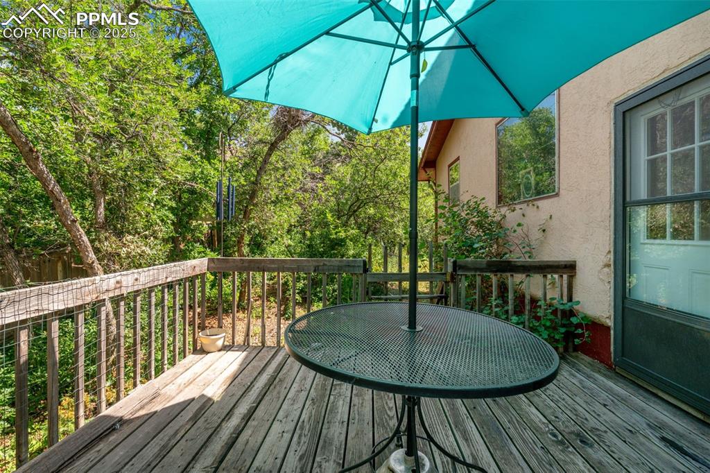 Image 17 of 50: Wooden deck with outdoor dining space