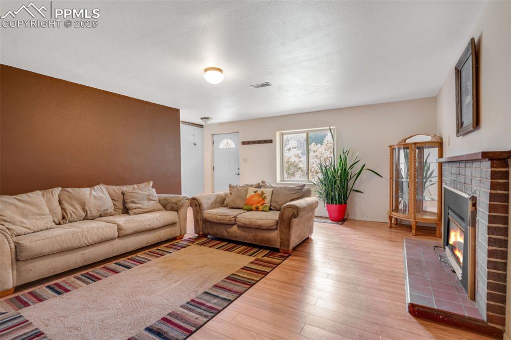 Image 25 of 50: Front door entry and large family room with gas fireplace