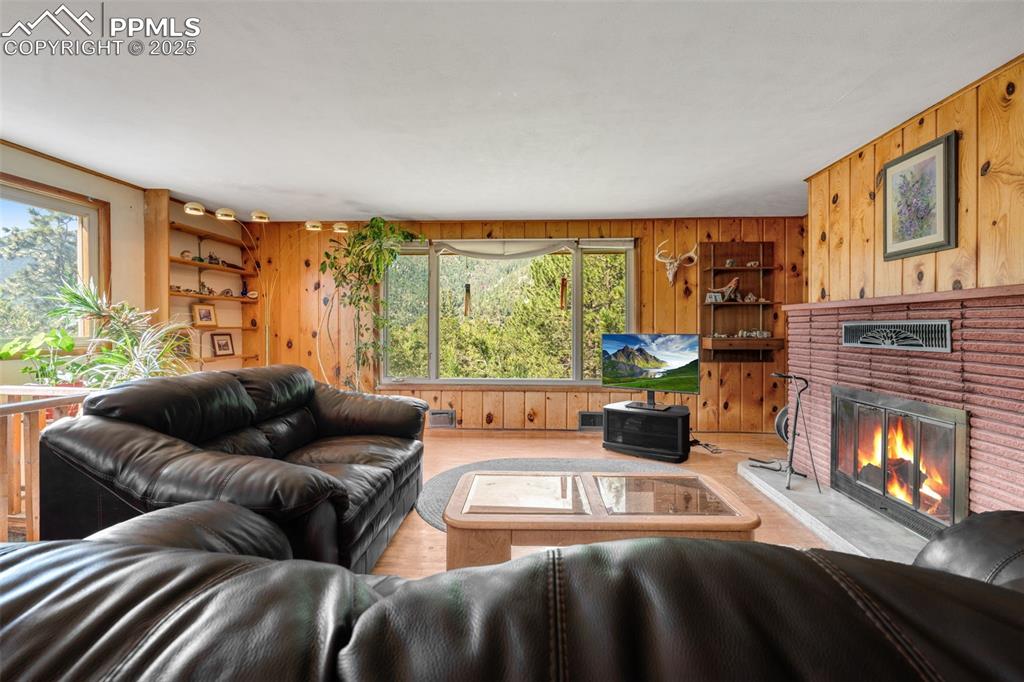 Image 4 of 50: Living room featuring 2 large windows with views and built-in shelving