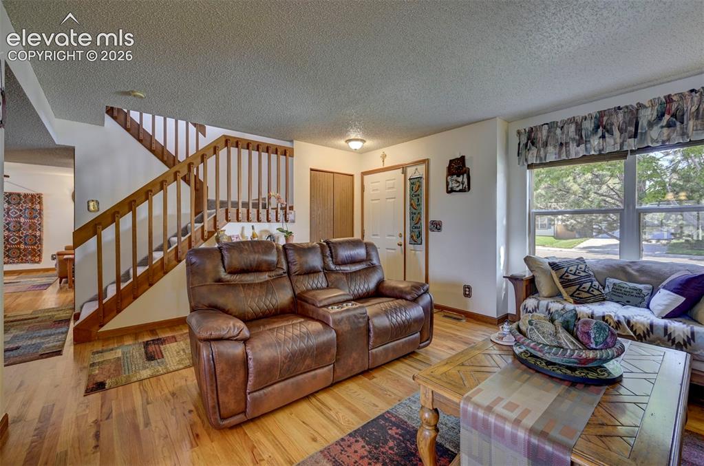 Image 2 of 50: Front entry into the Living room with beautiful hardwood flooring.