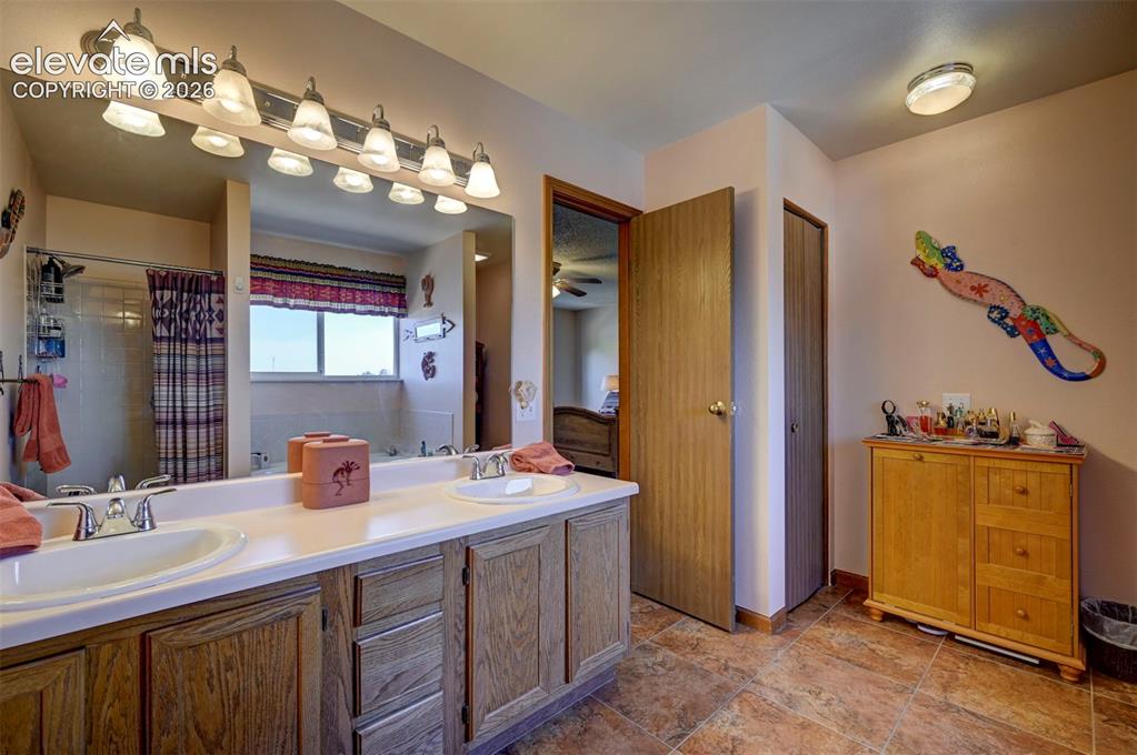 Image 25 of 50: Primary bathroom with double vanity, soaking tub and seperate shower.