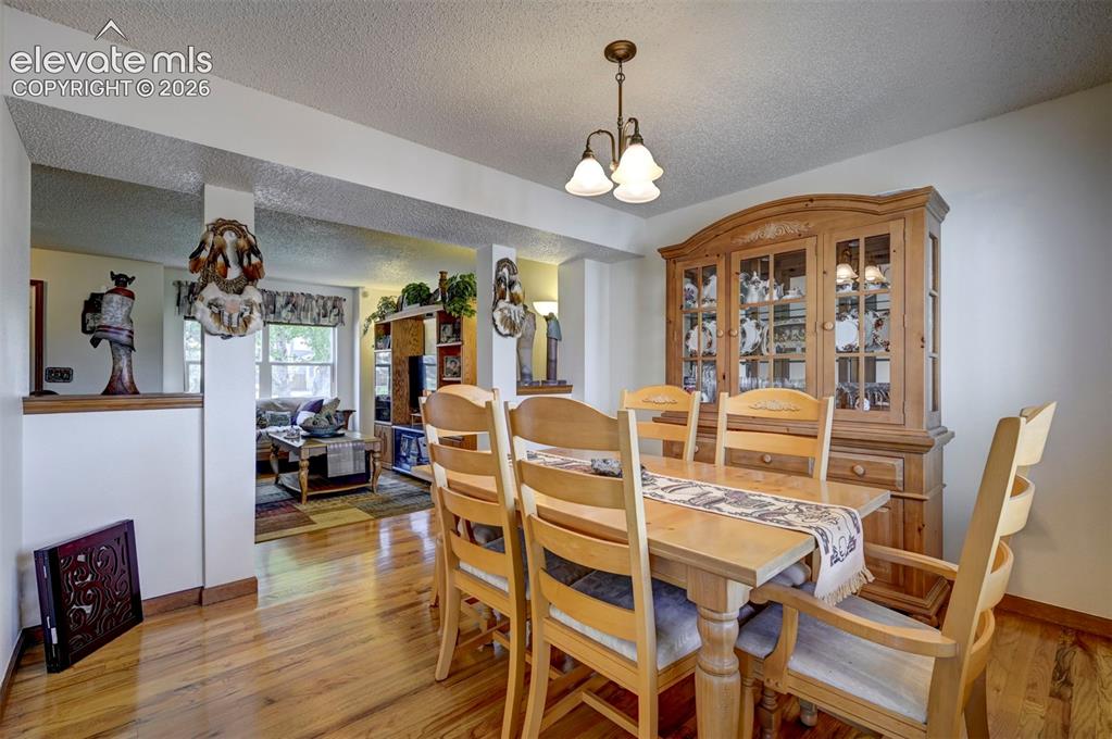 Image 5 of 50: Formal Dining room with hardwood flooring.
