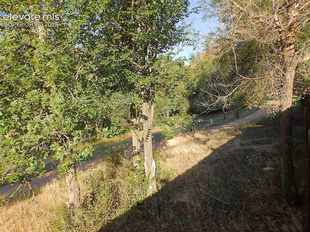 Image 20 of 20: walking trail behind the fence