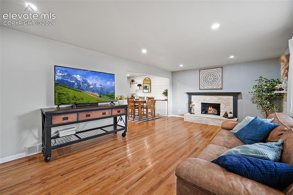 Image 4 of 36: Expansive living room with real hardwood floors